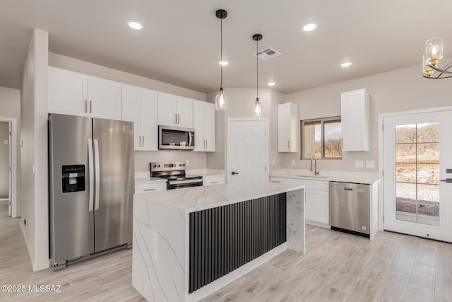 kitchen featuring light wood-style floors, white cabinetry, visible vents, and stainless steel appliances