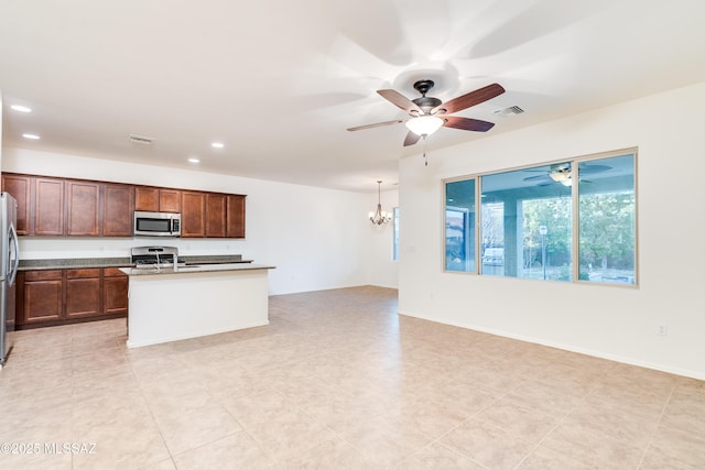 1091 E Empire Canyon Ln, Sahuarita, AZ 85629 - kitchen featuring ceiling fan with notable chandelier, stainless steel appliances, visible vents, open floor plan, and a center island with sink