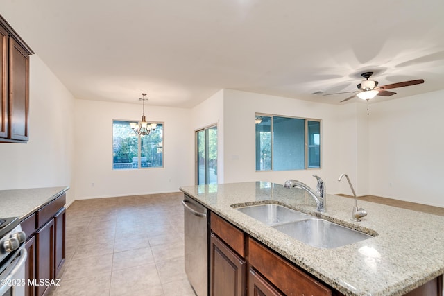 1091 E Empire Canyon Ln, Sahuarita, AZ 85629 - kitchen with light stone counters, stainless steel appliances, pendant lighting, a sink, and light tile patterned flooring