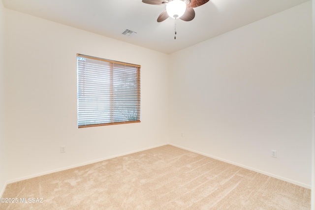 1091 E Empire Canyon Ln, Sahuarita, AZ 85629 - empty room with light carpet, baseboards, visible vents, and a ceiling fan