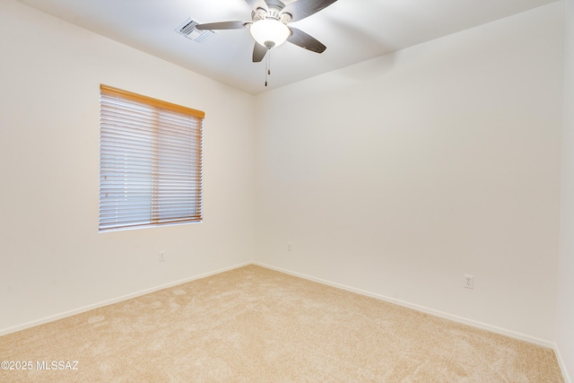 1091 E Empire Canyon Ln, Sahuarita, AZ 85629 - spare room featuring light carpet, ceiling fan, visible vents, and baseboards