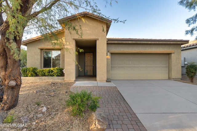 1091 E Empire Canyon Ln, Sahuarita, AZ 85629 - view of front of home featuring a garage, concrete driveway, a tile roof, and stucco siding