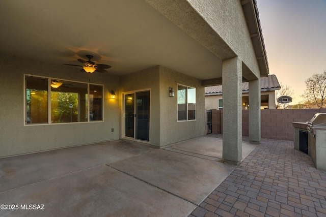 1091 E Empire Canyon Ln, Sahuarita, AZ 85629 - patio terrace at dusk featuring a grill, fence, and a ceiling fan