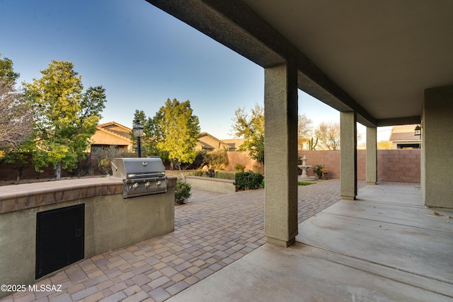1091 E Empire Canyon Ln, Sahuarita, AZ 85629 - view of patio / terrace featuring exterior kitchen, area for grilling, and a fenced backyard