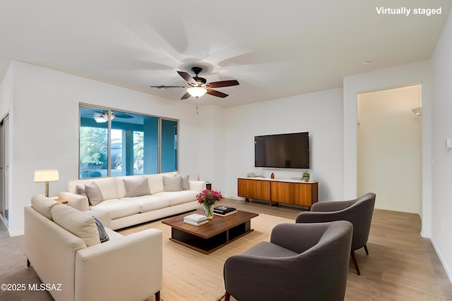 1091 E Empire Canyon Ln, Sahuarita, AZ 85629 - living room featuring light wood-style floors, ceiling fan, and baseboards