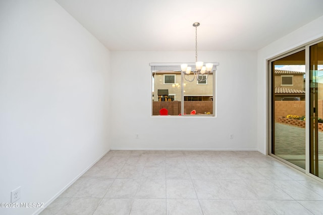 unfurnished room featuring a chandelier, tile patterned floors, and baseboards