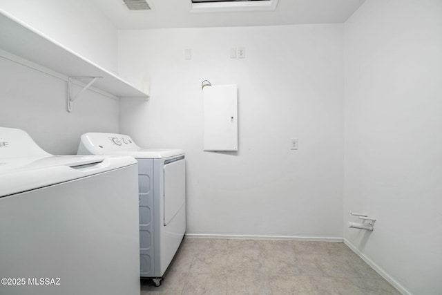 clothes washing area featuring laundry area, visible vents, independent washer and dryer, and baseboards