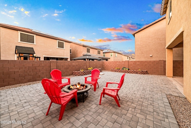 view of patio / terrace featuring an outdoor fire pit and a fenced backyard