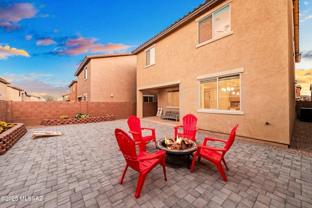 view of patio with a fire pit and fence