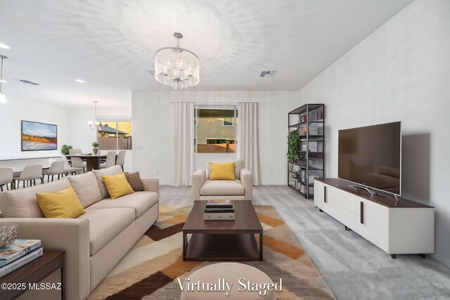 living area featuring light carpet, visible vents, a chandelier, and recessed lighting