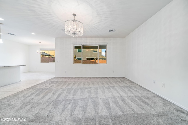 carpeted spare room with recessed lighting, tile patterned floors, visible vents, and an inviting chandelier