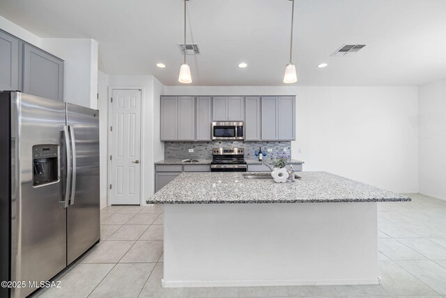 kitchen with tasteful backsplash, gray cabinets, visible vents, and stainless steel appliances