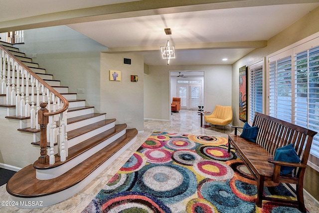 living room featuring beam ceiling, stairway, visible vents, and baseboards