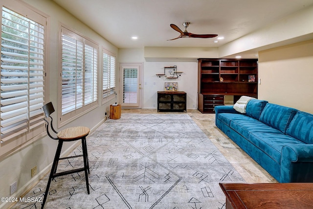 living area featuring recessed lighting, baseboards, and ceiling fan