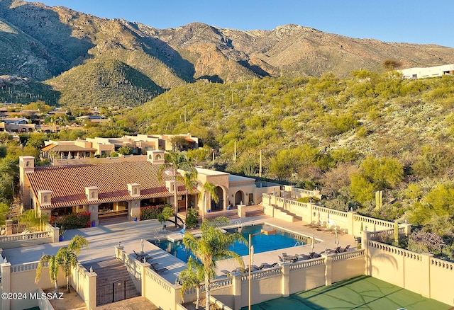 exterior space featuring a patio area, fence, and a mountain view