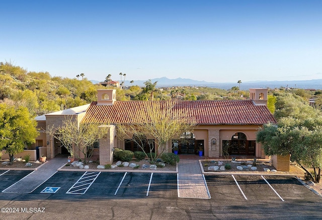 view of property with uncovered parking and a mountain view