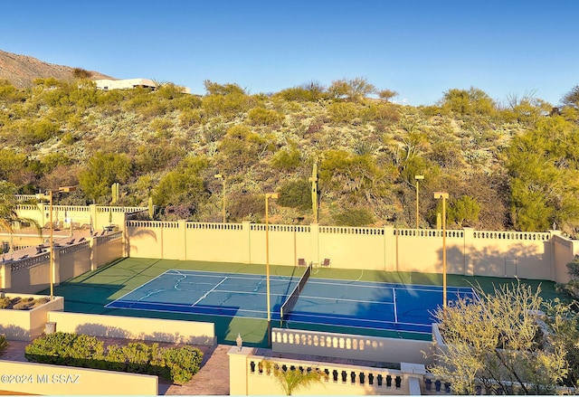 view of sport court featuring fence