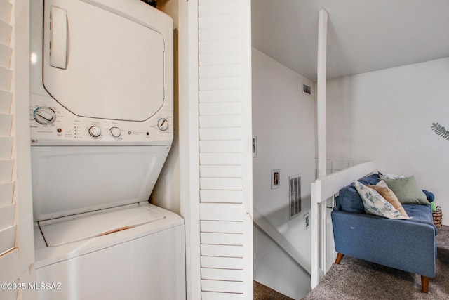 washroom with visible vents, stacked washer and dryer, carpet, and laundry area