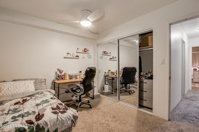 carpeted bedroom with a ceiling fan and a closet