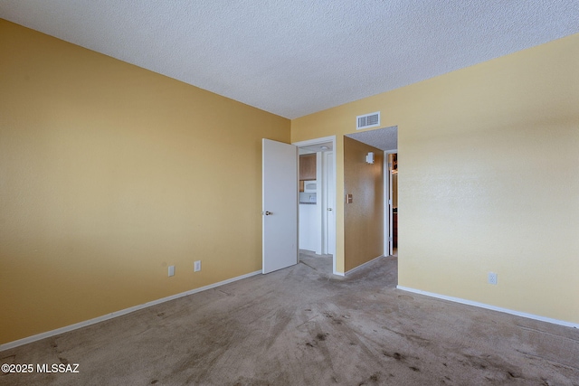 unfurnished bedroom with carpet floors, baseboards, visible vents, and a textured ceiling