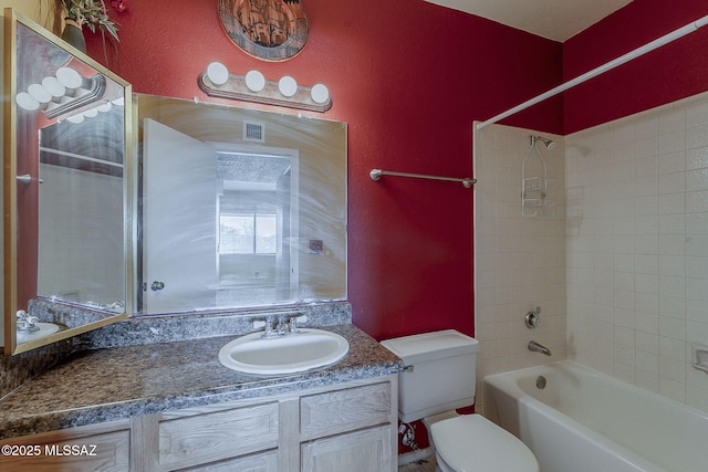 bathroom with visible vents, a textured wall, toilet, vanity, and shower / bathing tub combination