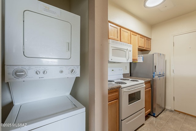 kitchen with white appliances, light brown cabinets, and stacked washer / drying machine