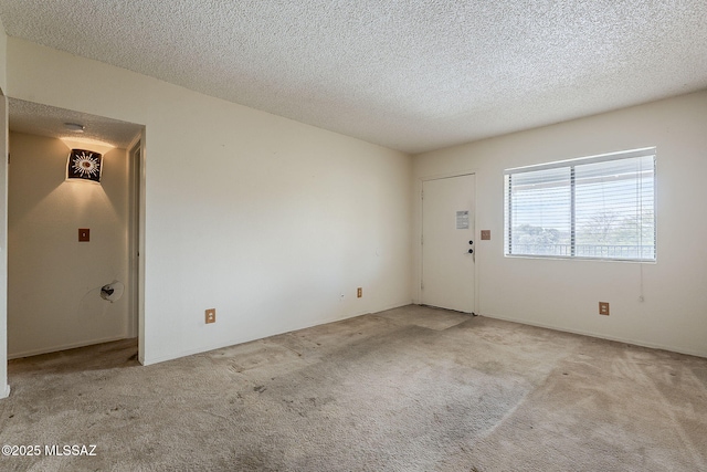 carpeted spare room with a textured ceiling