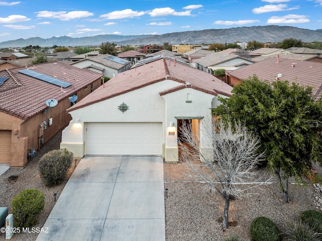 view of front of property featuring a tile roof, a mountain view, and stucco siding