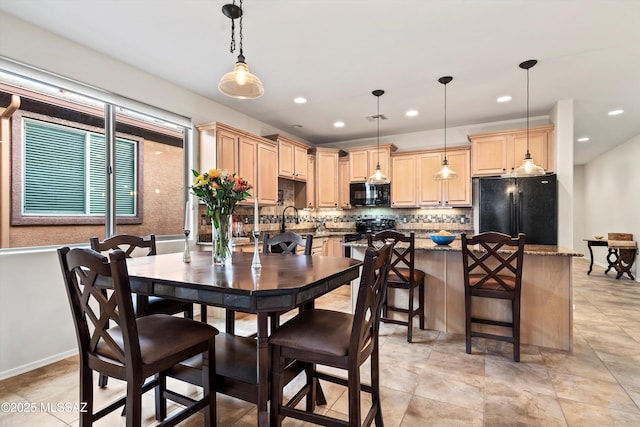 dining area featuring recessed lighting and baseboards