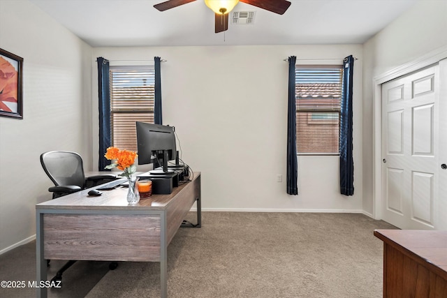 carpeted office featuring baseboards, visible vents, and a wealth of natural light