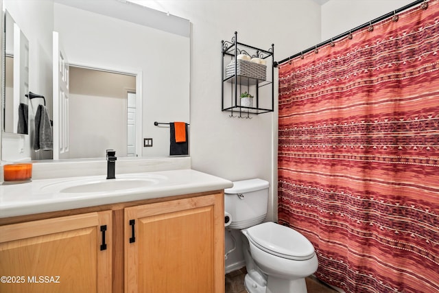 bathroom featuring curtained shower, vanity, and toilet