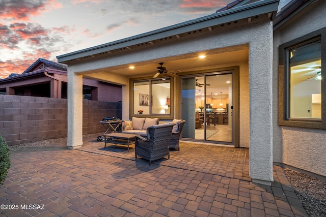 patio terrace at dusk featuring fence