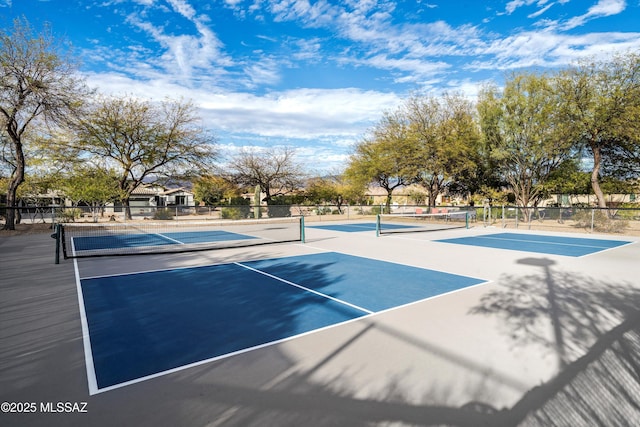 view of tennis court featuring fence