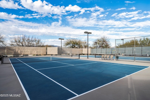 view of sport court featuring fence