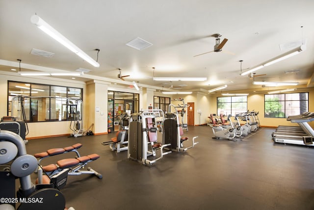 exercise room with a ceiling fan and baseboards