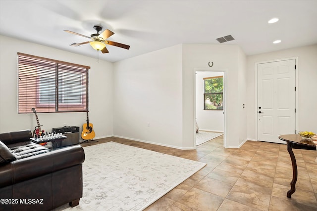 living area with recessed lighting, visible vents, ceiling fan, and baseboards