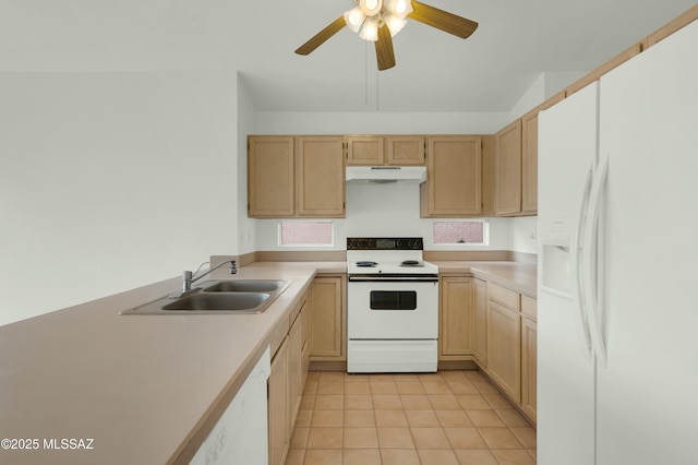 kitchen with light brown cabinets, under cabinet range hood, white appliances, a sink, and light countertops