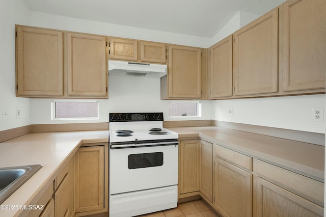 kitchen featuring white electric stove, light countertops, under cabinet range hood, light brown cabinets, and light tile patterned flooring