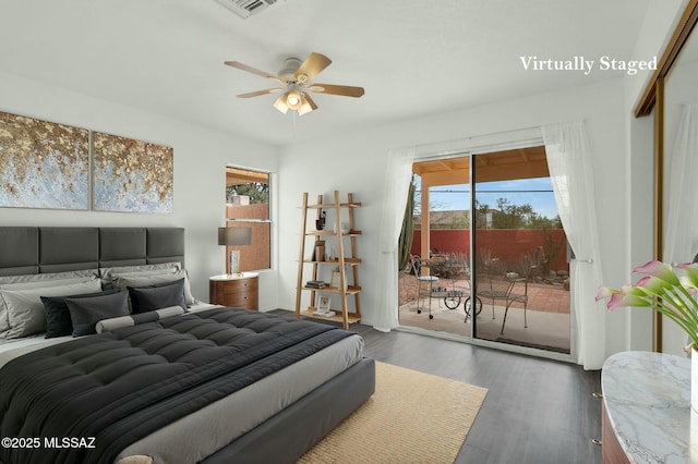 bedroom featuring access to exterior, a ceiling fan, visible vents, and wood finished floors