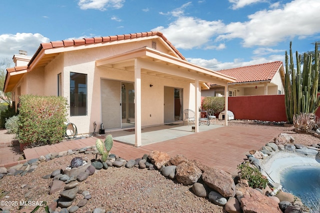 back of house with a patio, fence, and stucco siding