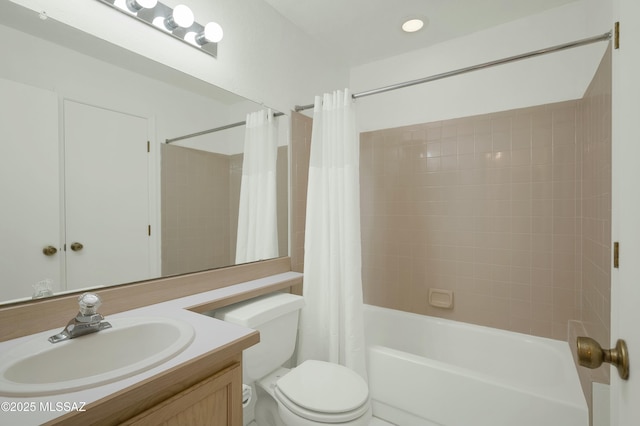 full bathroom with vanity, toilet, and shower / tub combo with curtain