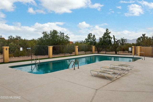 community pool featuring a patio area and fence