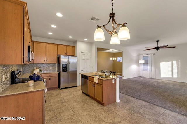 60579 E Flank Strap Dr, Tucson, AZ 85739 - kitchen featuring tasteful backsplash, visible vents, light colored carpet, stainless steel appliances, and a sink