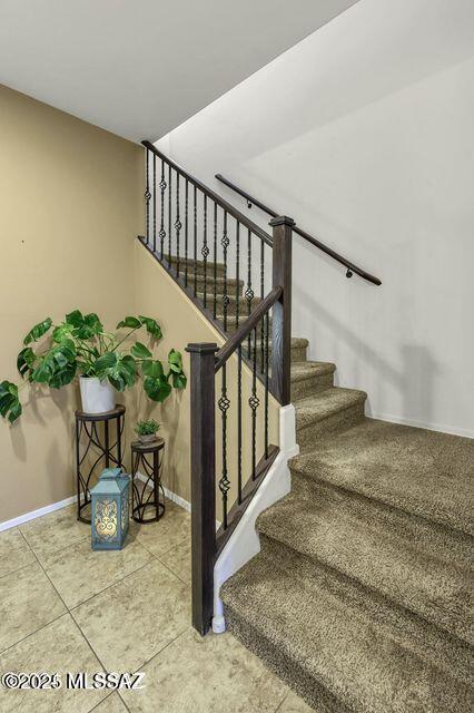 60579 E Flank Strap Dr, Tucson, AZ 85739 - staircase with tile patterned flooring and baseboards