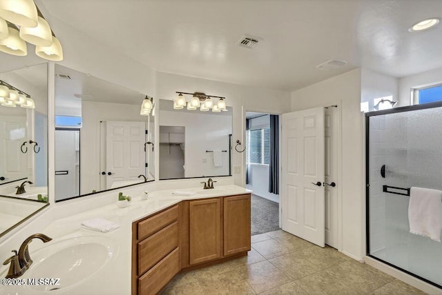 60579 E Flank Strap Dr, Tucson, AZ 85739 - bathroom with double vanity, a shower stall, visible vents, and a sink