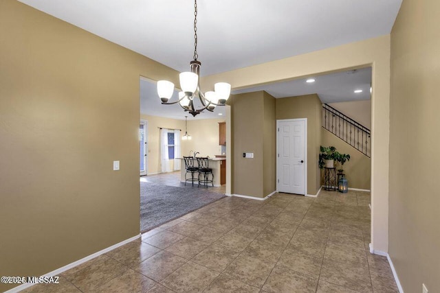 60579 E Flank Strap Dr, Tucson, AZ 85739 - unfurnished room with a chandelier, recessed lighting, baseboards, stairs, and tile patterned floors