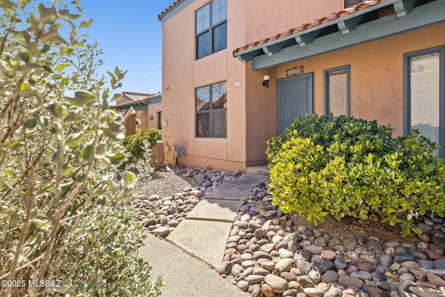 entrance to property with stucco siding