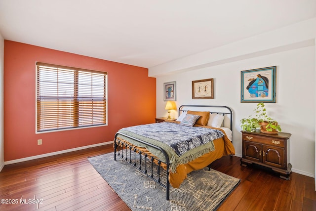 bedroom featuring baseboards and hardwood / wood-style flooring