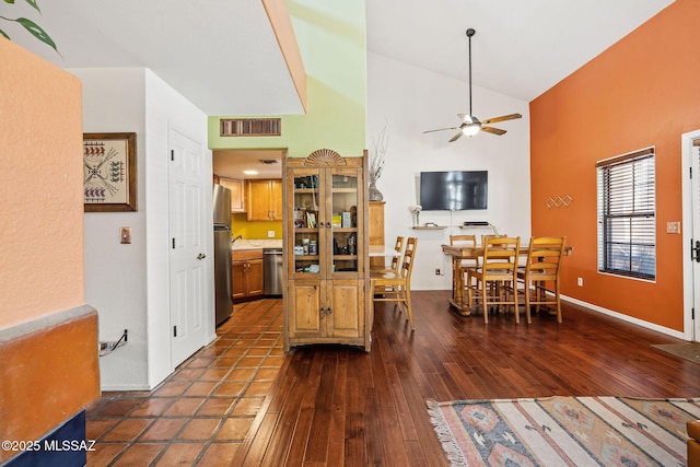 kitchen featuring visible vents, brown cabinets, a ceiling fan, dark wood finished floors, and stainless steel appliances