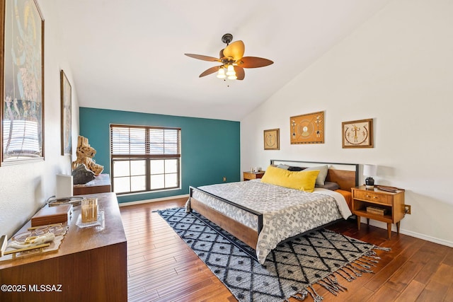 bedroom with baseboards, high vaulted ceiling, hardwood / wood-style floors, and a ceiling fan